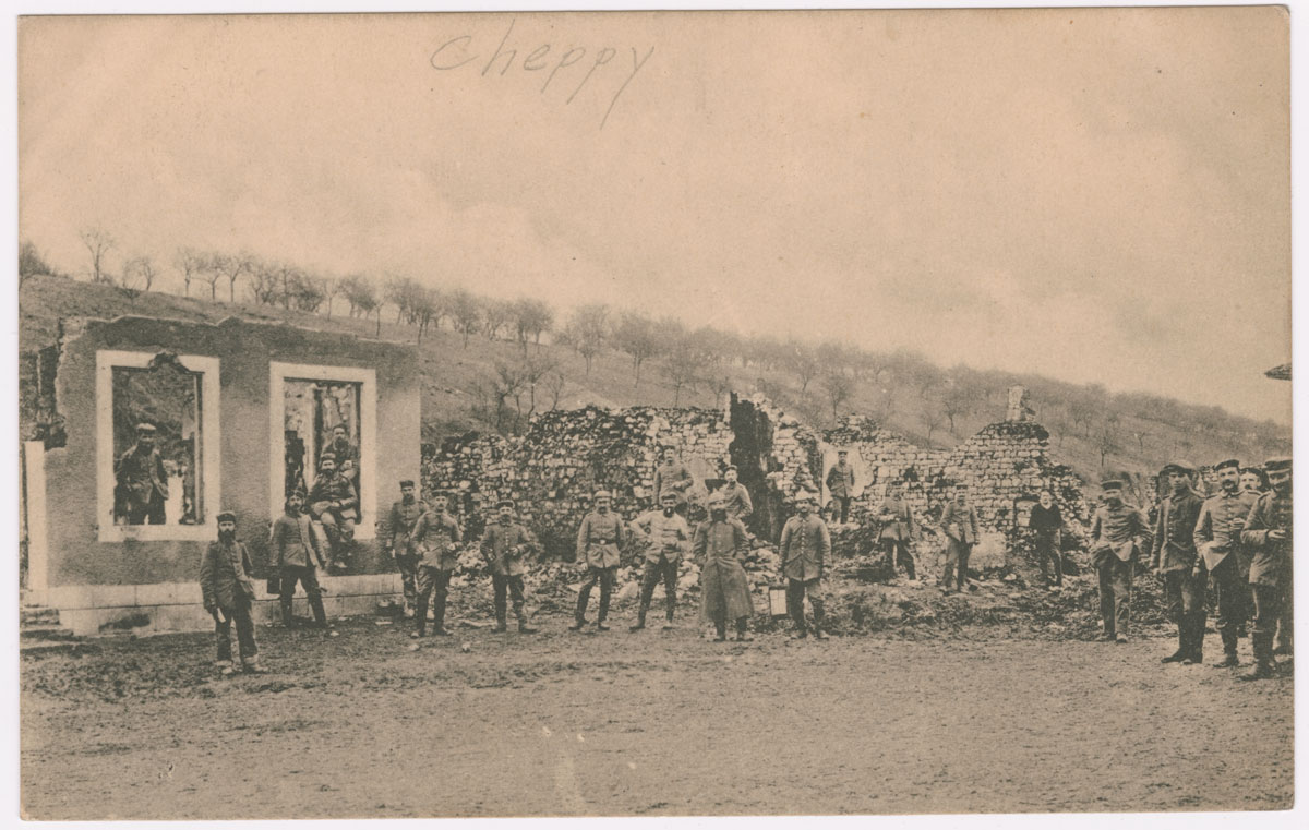 A black, white, and sepia photograph of WWI soldiers in front of ruins of a building.