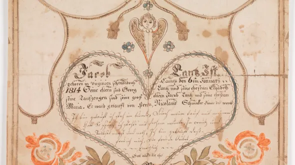 Fraktur. This Lutheran baptismal certificate (Taufschein) for Jacob Lantz (b. 1814) was created by the Stoney Creek artist Henry Heltzel. Most of his work done for individuals in Shenandoah County between Edinburg and Mt. Jackson. This certificate descended in the Ralph W. Stoneburner family of Edinburg, VA. Text of the certificate is in German and is encircled by a large heart. (Object Number  1997.83)