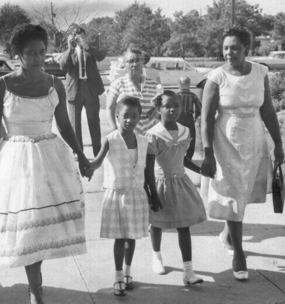 Two young girls holding their mother's hands as they arrive at school in Norfolk, Virginia, 1959.