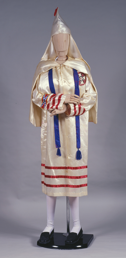 Wooden figurine dressed in a Ku Klux Klan robe     