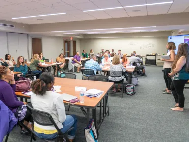 Teachers attending professional development training in a classroom at the VMC