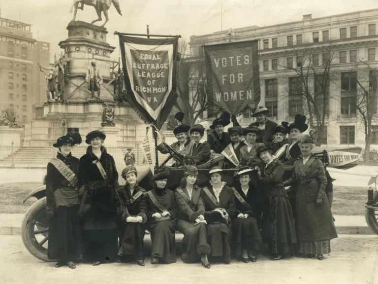 Sepia-toned group photo of the Equal Suffrage League of Virginia at the Virginia State Capitol in February 1915. Adèle Clark is at the far left.