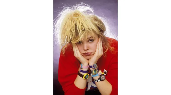 A color photograph of Stephanie Lane wearing seven Swatch watches. Image courtesy of the Richmond Times-Dispatch. 