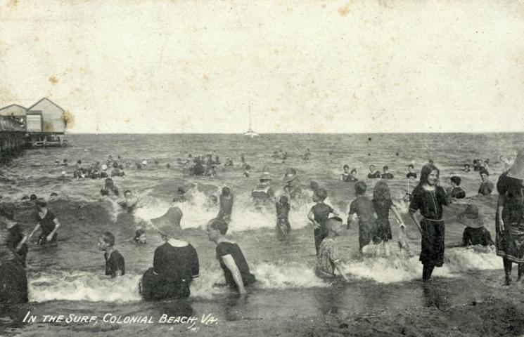 Colonial Beach (VHS accession number: 1999.17.1852). Black and white photograph postcard, in the surf, Colonial Beach, Va. Photograph probably taken early 20th century. Correspondence on the back, stamped, postmarked Aug. 11, 1910. paper, 8.89 cm x 13.97 cm. Colonial Beach