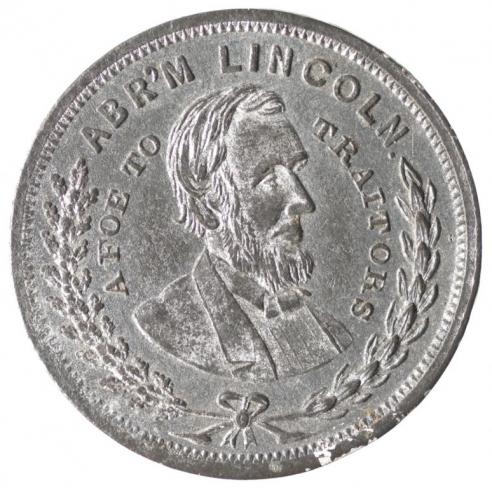 A silver Abraham Lincoln medalet with the side profile of Lincoln and the words, “ABR’M LINCOLN / A FOE TO TRAITORS.”