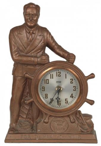 A cast-metal clock with a figure of Franklin Roosevelt steering a ship’s wheel, bearing the inscription "F.D.R The Man of The Hour”