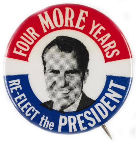 Red white and blue button with the text, “FOUR MORE YEARS / RE-ELECT THE PRESIDENT” around a black and white photograph of Richard Nixon.  