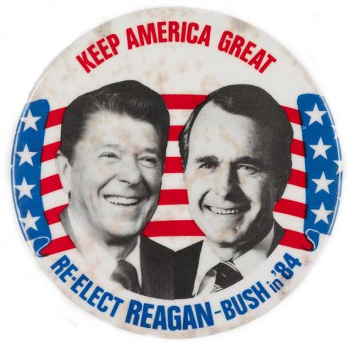 White button with black and white photographs of Ronald Reagan and George Bush surrounded by the text, “KEEP AMERICA GREAT / RE-ELECT REAGAN – BUSH in ’84.”