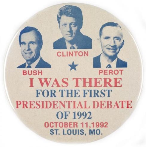 A tan button with photographs of George H.W. Bush, Bill Clinton, and Ross Perot with the text, “I WAS THERE FOR THE FIRST PRESIDENTIAL DEBATE OF 1992, OCTOBER 11, 192, ST. LOUIS, MO.”