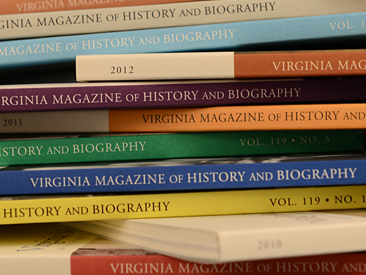 A stack of journals with spines of different colors read "Virginia Magazine of History and Biography"